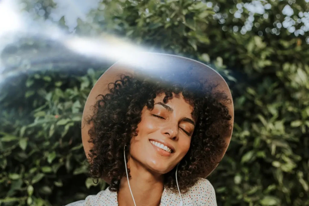 black woman smiling sunlight mental wellness