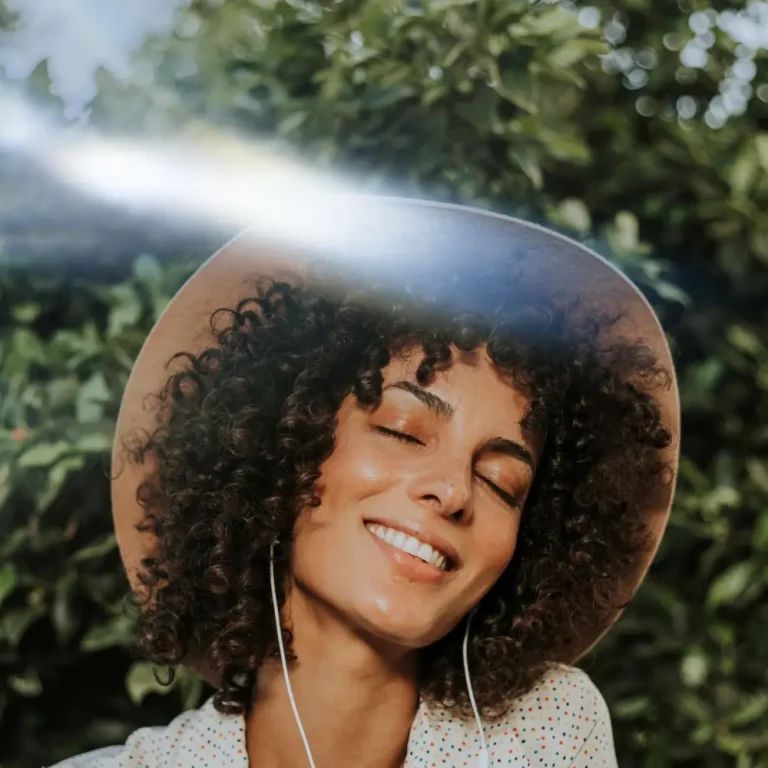 black woman smiling sunlight mental wellness